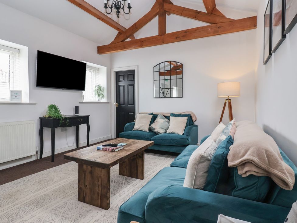 A living room with a sofa and coffee table at Gannet in Flamborough