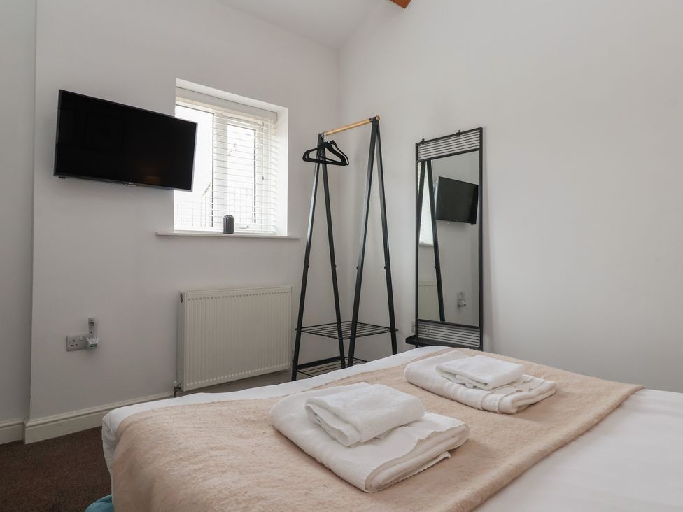 A bedroom with a bed and towels on it at Gannet in Flamborough