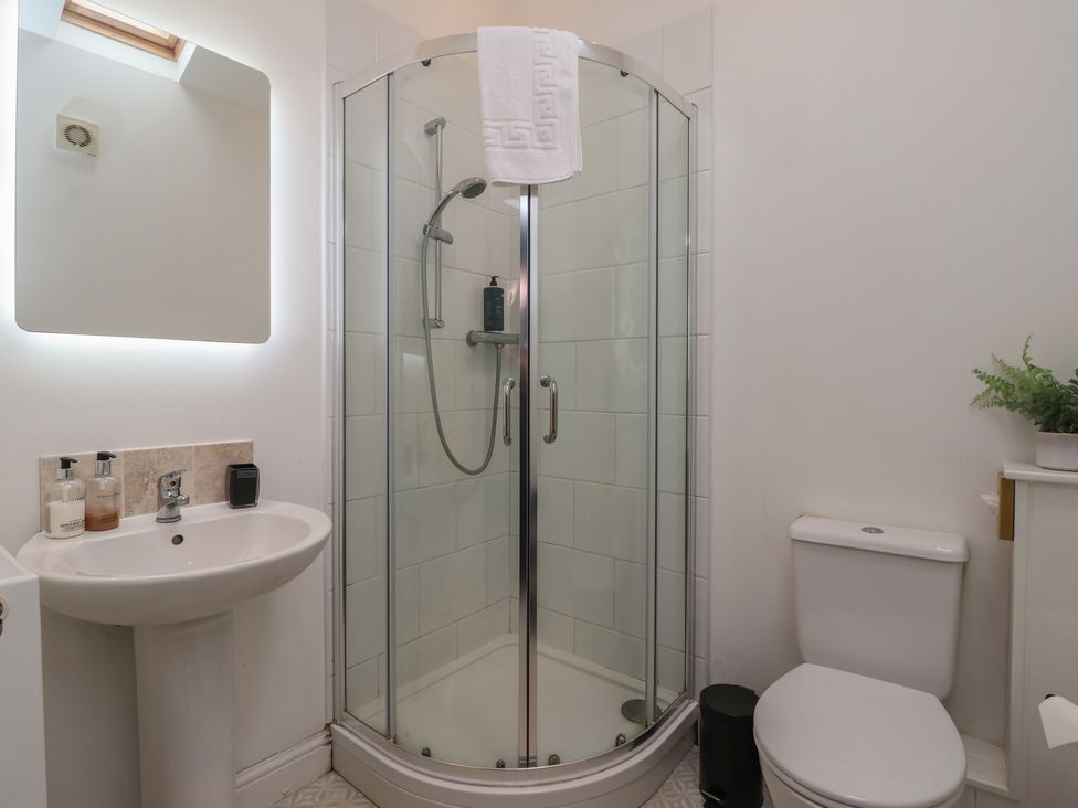 A bathroom with shower, toilet, and sink at Gannet in Flamborough