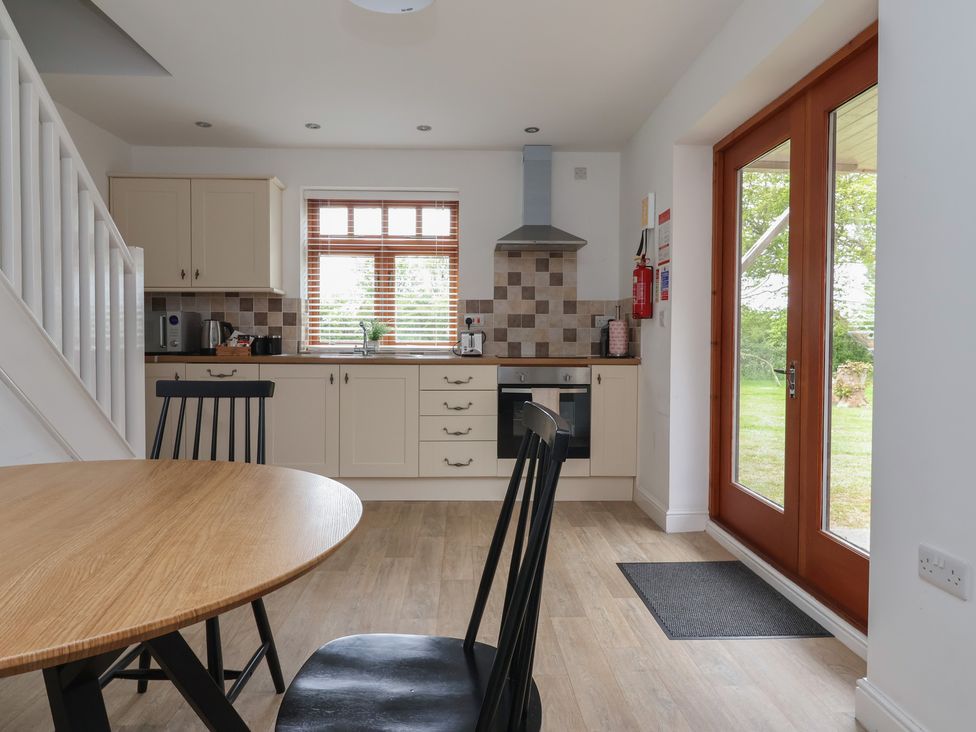 A kitchen with a table and chairs at Razorbill in Flamborough