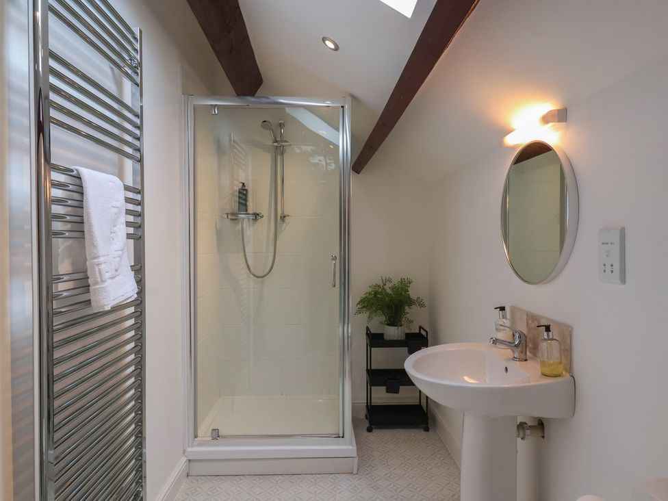 A bathroom with a shower and sink at Razorbill in Flamborough