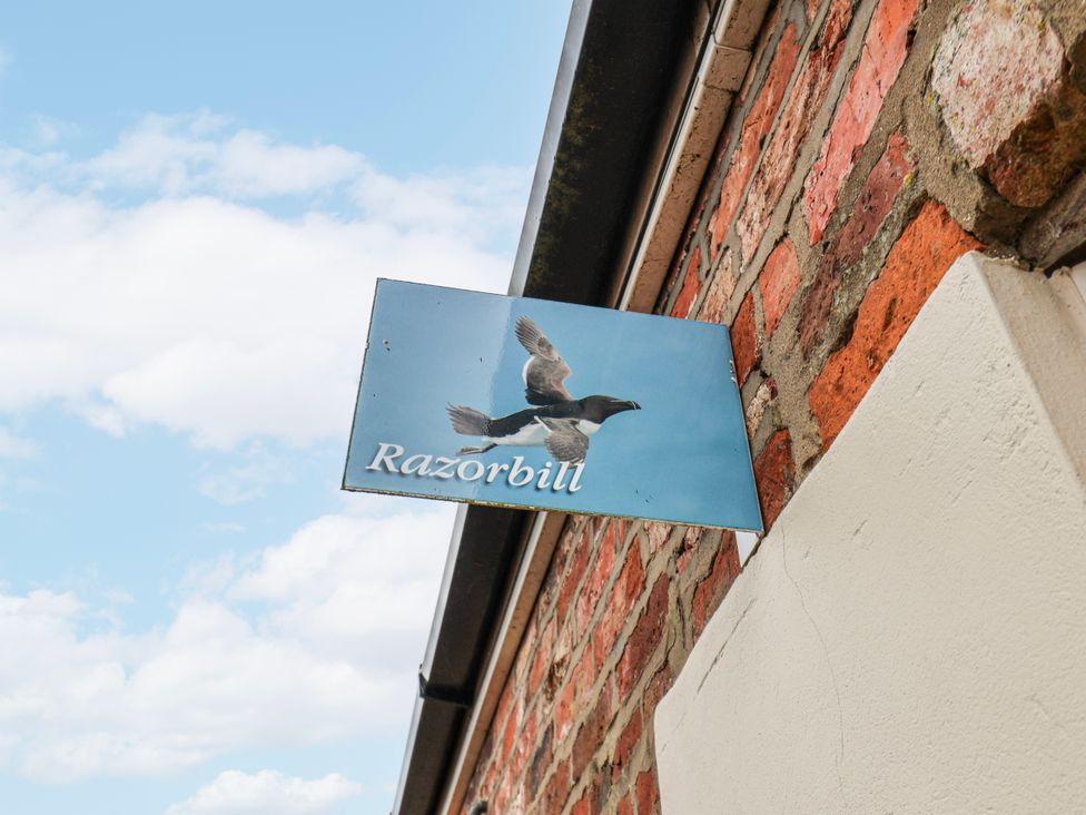 A sign with a bird graphic at Razorbill in Flamborough