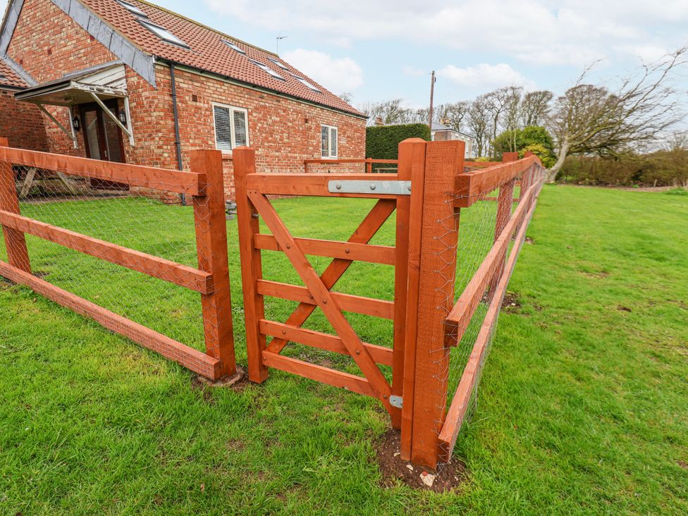 A fence and gate in front of a house at Razorbill in Flamborough