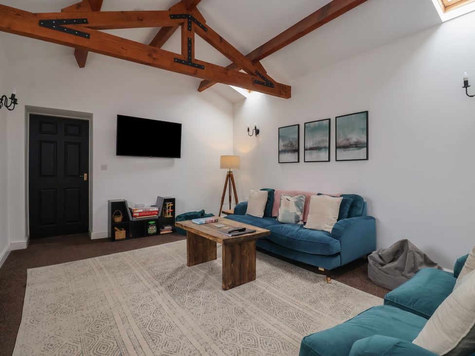 A living room with a sofa and coffee table at Puffin in Flamborough