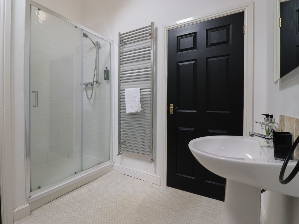 A bathroom with a shower and sink at Puffin Flamborough