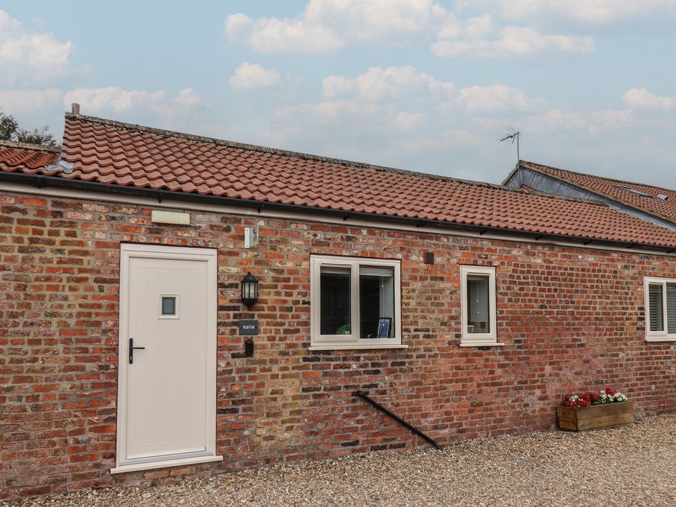 An exterior view of Puffin in Flamborough with a door and windows