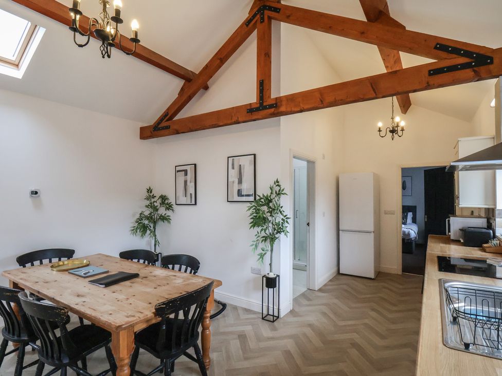 A dining room with a table and chairs at Puffin in Flamborough
