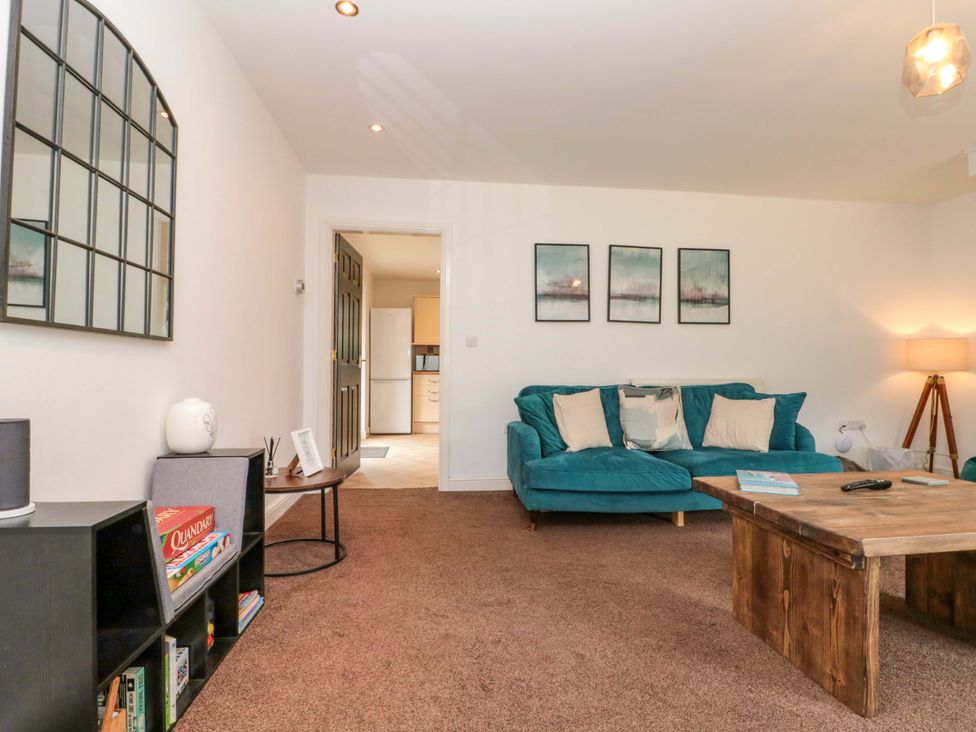 A living room with a sofa and coffee table at Kittiwake in Flamborough