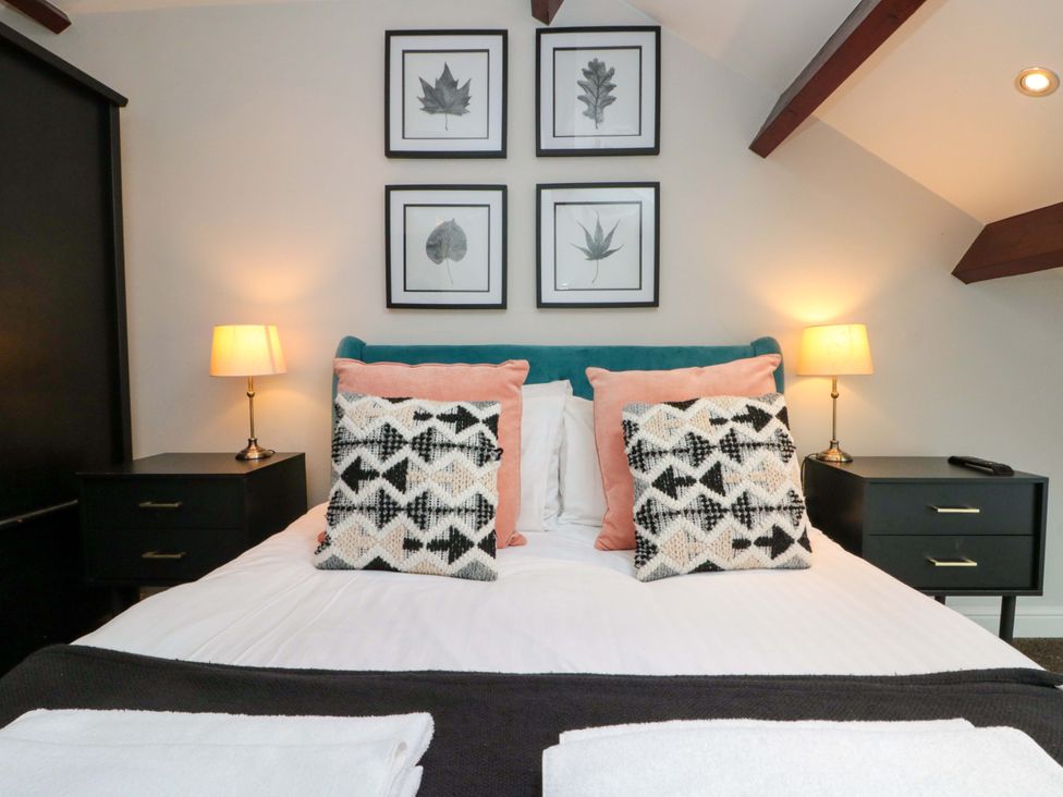 A bedroom with a bed and bedside tables at Kittiwake in Flamborough