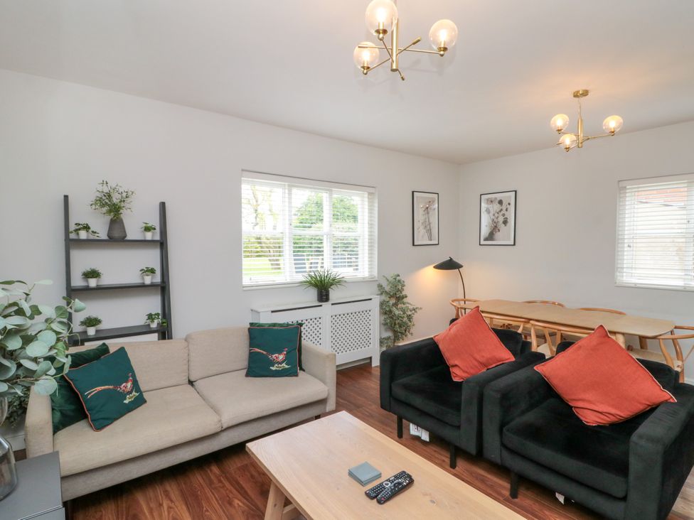 A living room with a sofa and coffee table at The Pheasantry in Flamborough