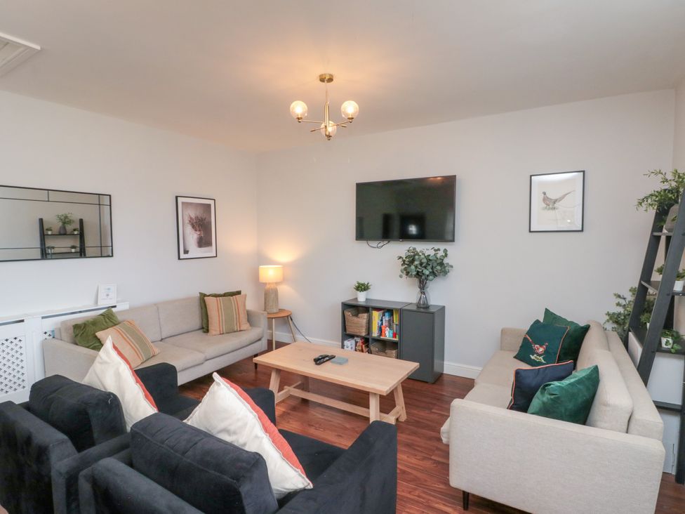 A living room with sofas and a TV at The Pheasantry in Flamborough