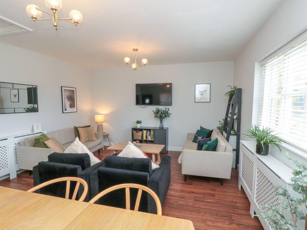A living room with sofas and a television at The Pheasantry in Flamborough
