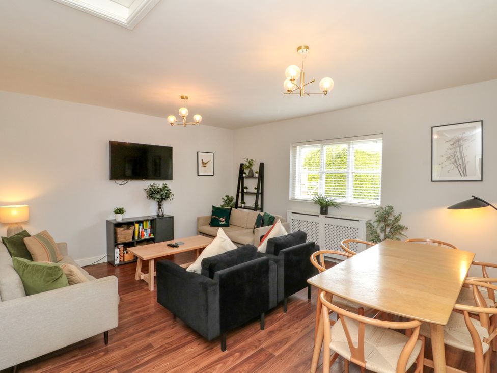 A living room with a sofa and television at The Pheasantry in Flamborough