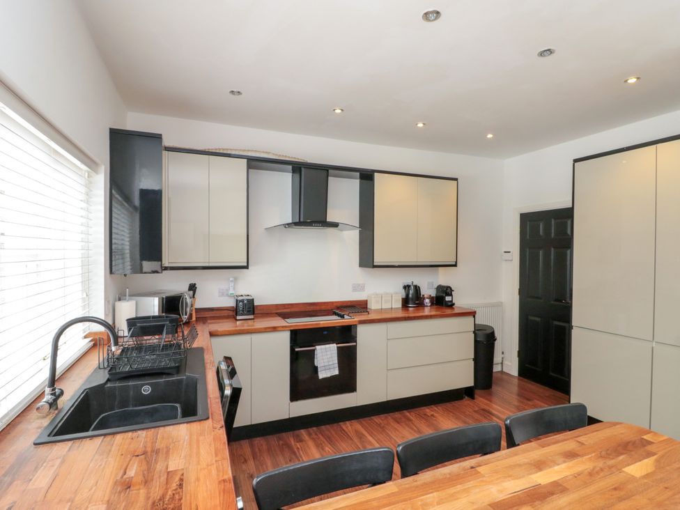 A kitchen with modern appliances and wooden countertops at The Pheasantry in Flamborough