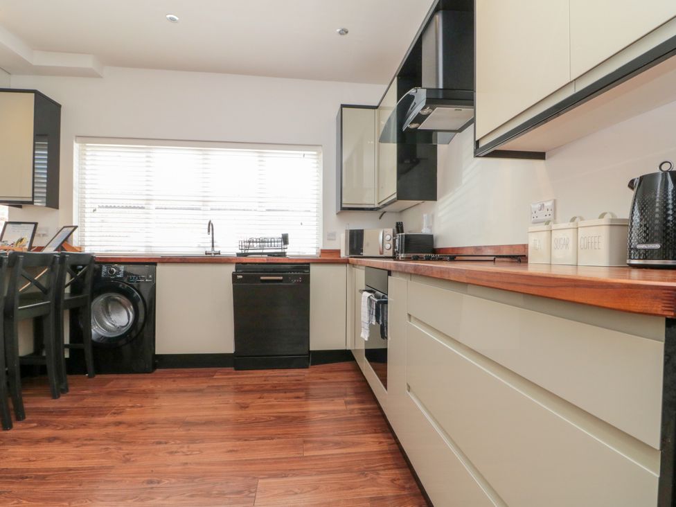 A kitchen with appliances and cabinets at The Pheasantry in Flamborough
