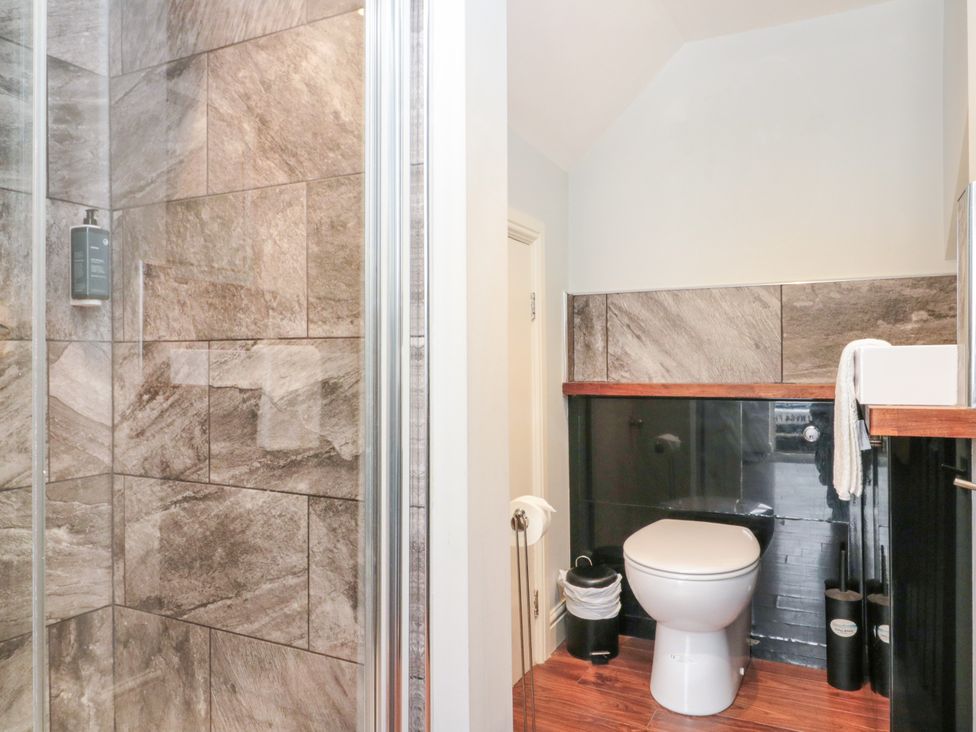 A bathroom with a shower and toilet at The Pheasantry in Flamborough