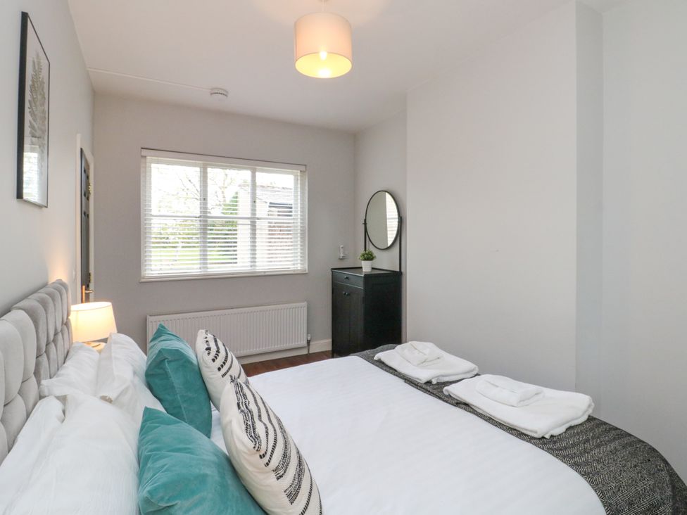 A bedroom with a bed and dresser at The Pheasantry in Flamborough