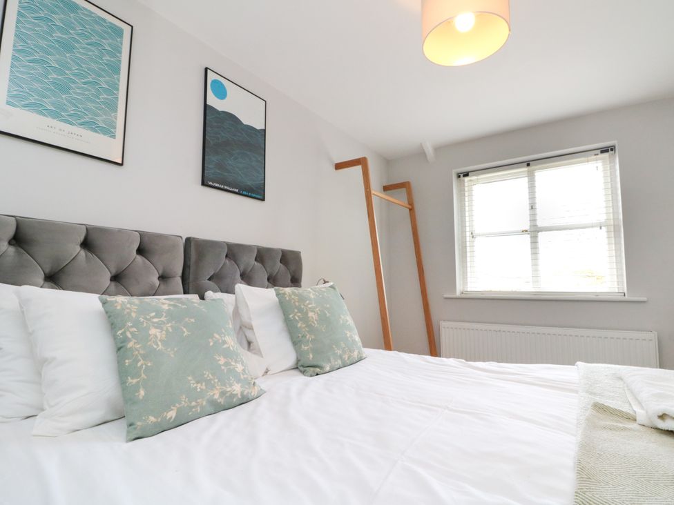 A bedroom with a bed and decorations on the wall at The Pheasantry in Flamborough