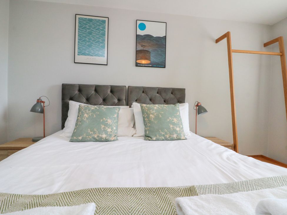 A bedroom with bed and wall art at The Pheasantry in Flamborough