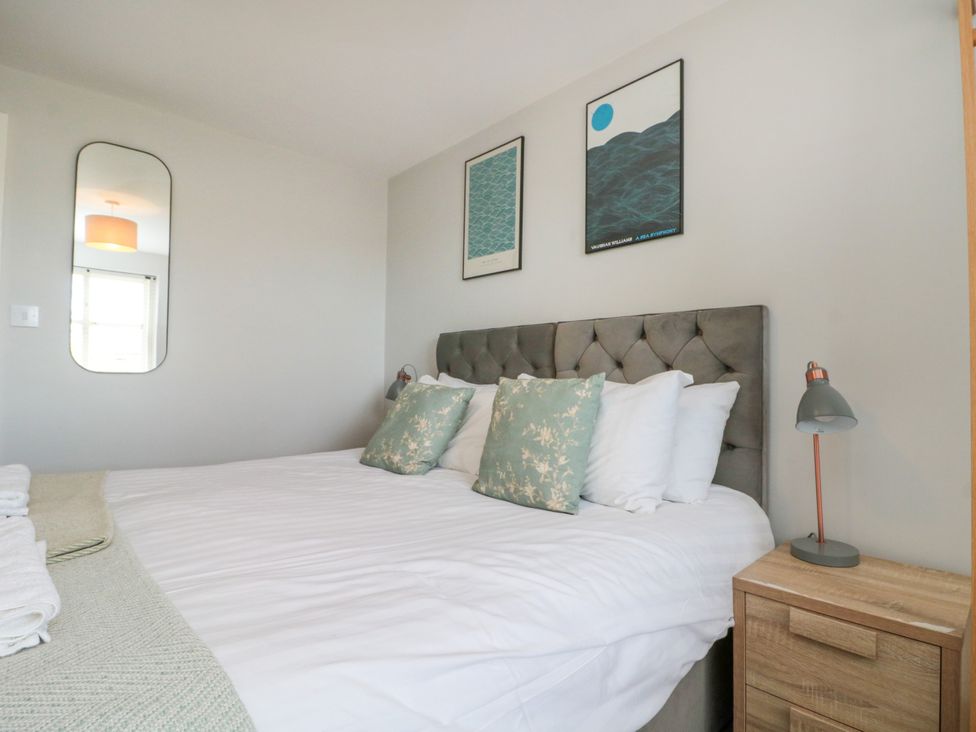 A bedroom with a bed and lamp at The Pheasantry in Flamborough