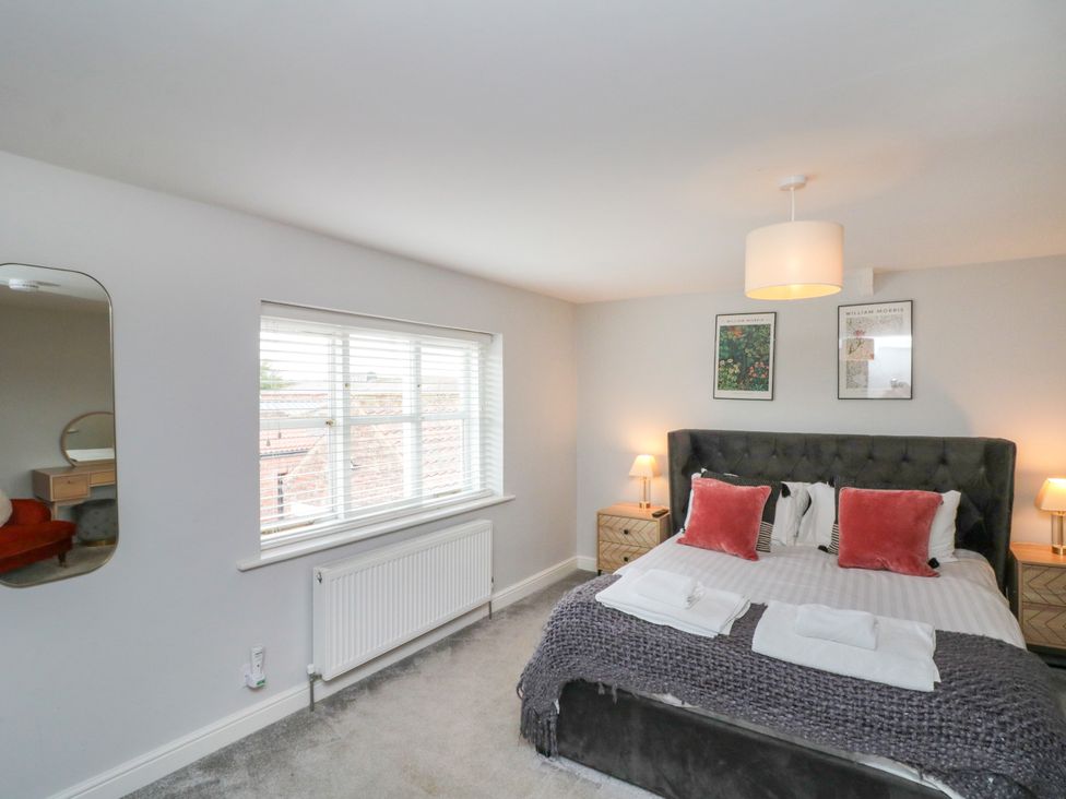 A bedroom with a bed and bedside tables at The Pheasantry in Flamborough