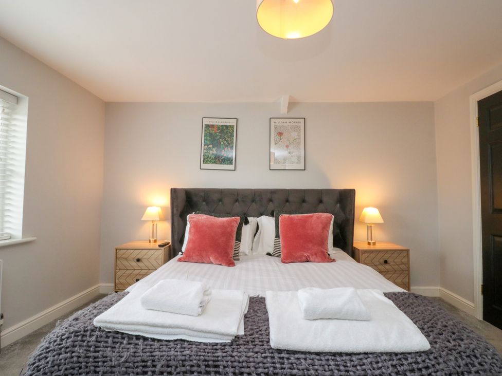 A bedroom with a bed and bedside tables at The Pheasantry in Flamborough