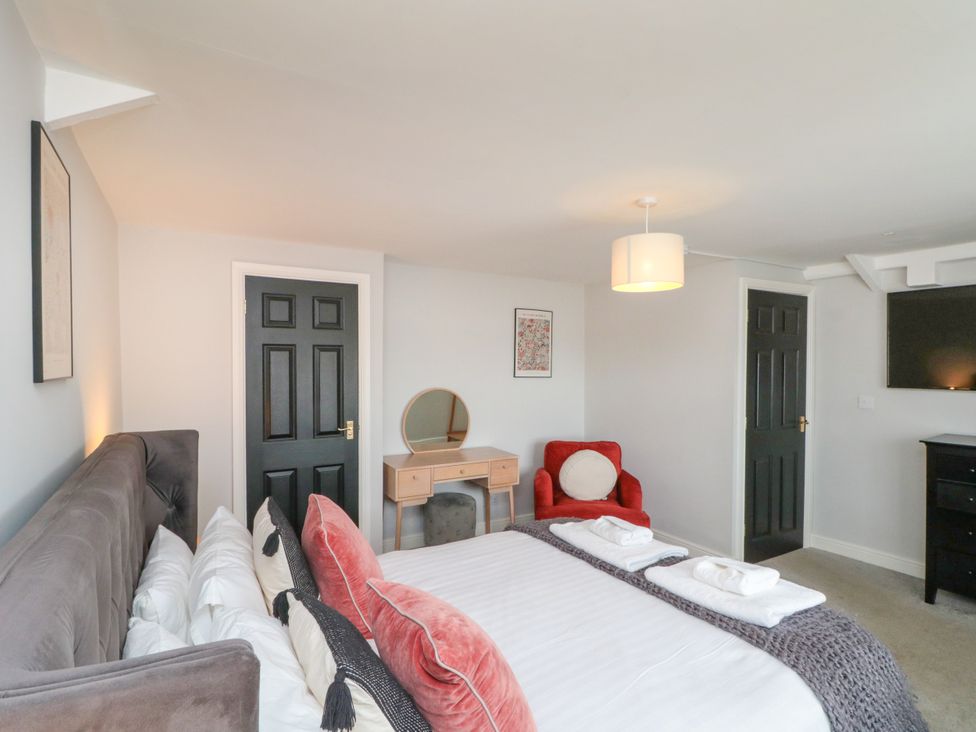 A bedroom with a bed and dressing table at The Pheasantry in Flamborough