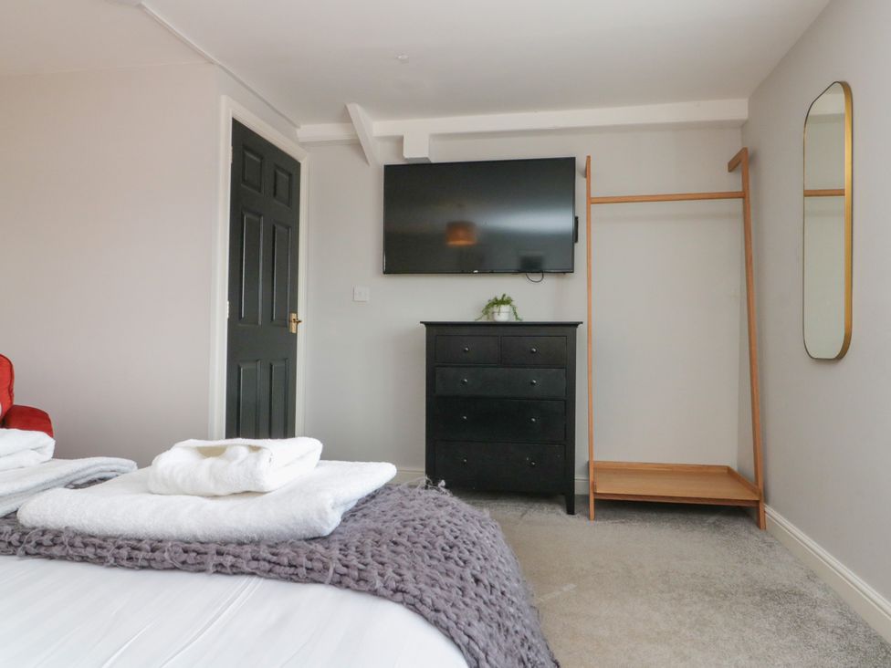 A bedroom with a bed and television at The Pheasantry in Flamborough