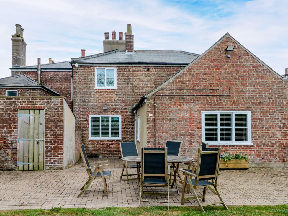 An outdoor patio with a table and chairs at The Pheasantry in Flamborough