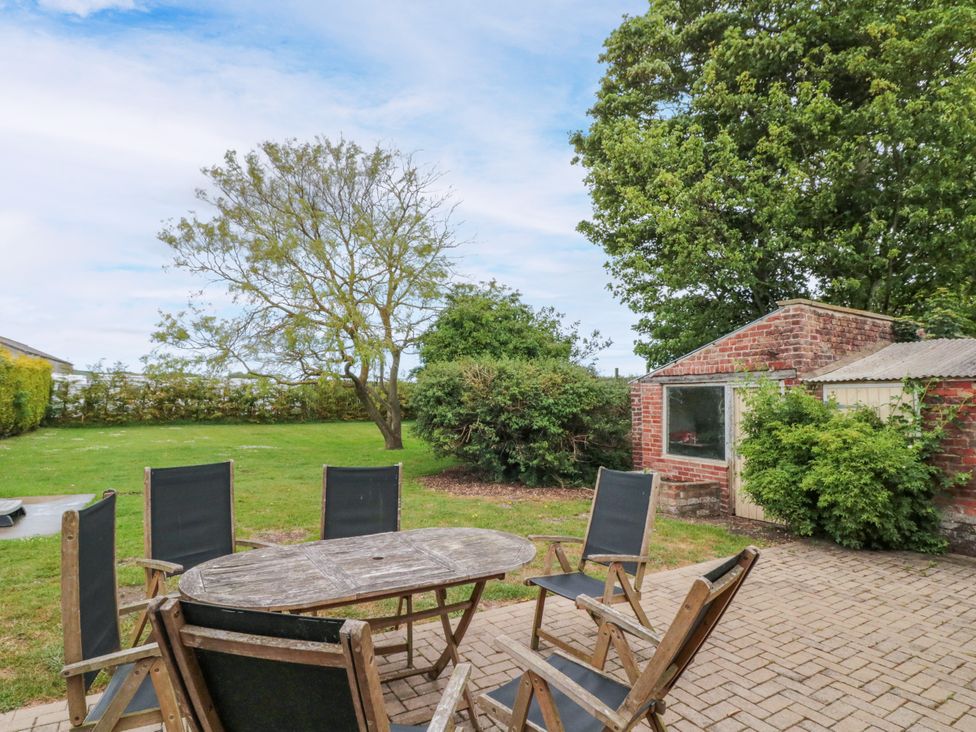 A garden with a table and chairs at The Pheasantry in Flamborough