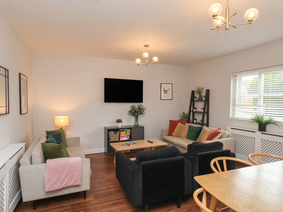 A living room with sofas and a coffee table at The Pheasantry in Flamborough
