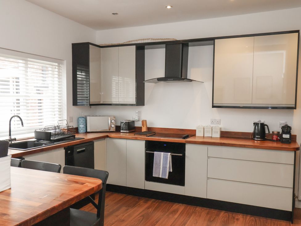 A kitchen with a sink and countertop appliances at The Pheasantry in Flamborough