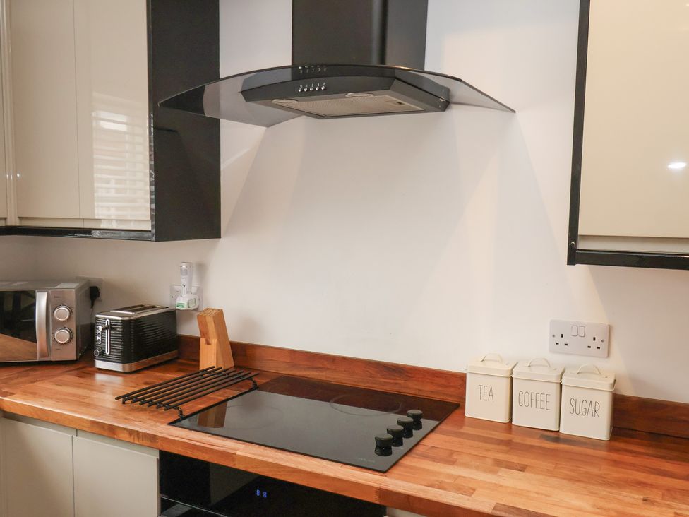A kitchen with a microwave, toaster, and cooktop at The Pheasantry in Flamborough