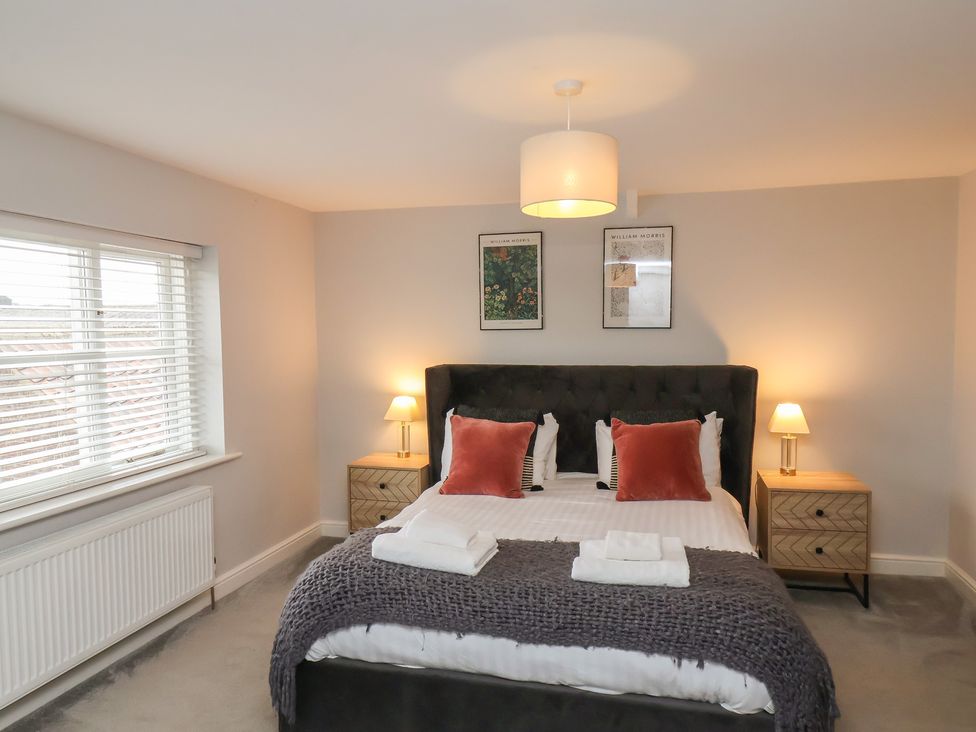 A bedroom with a bed and bedside tables at The Pheasantry in Flamborough