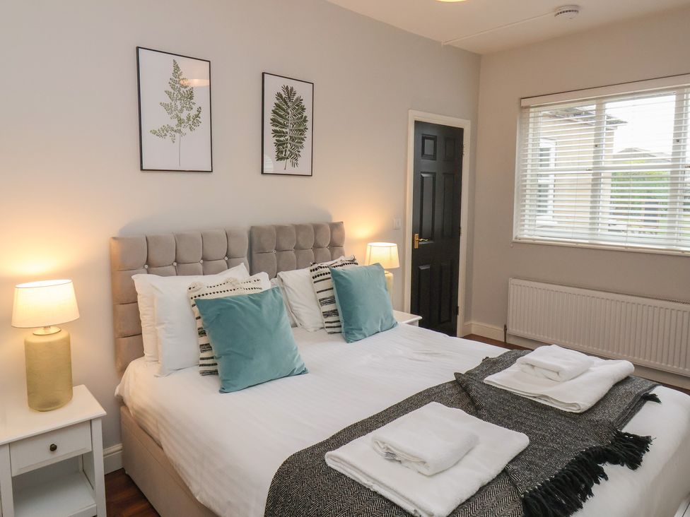 A bedroom with a bed and bedside table at The Pheasantry in Flamborough