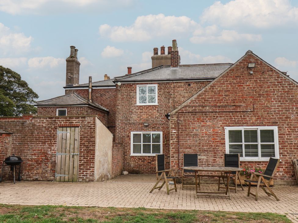 An outdoor area with a table and chairs at The Pheasantry in Flamborough