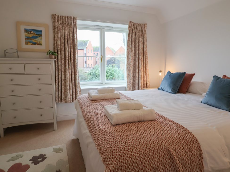 A bedroom with a bed and a dresser at 9 Church Farm Rise in Aldeburgh