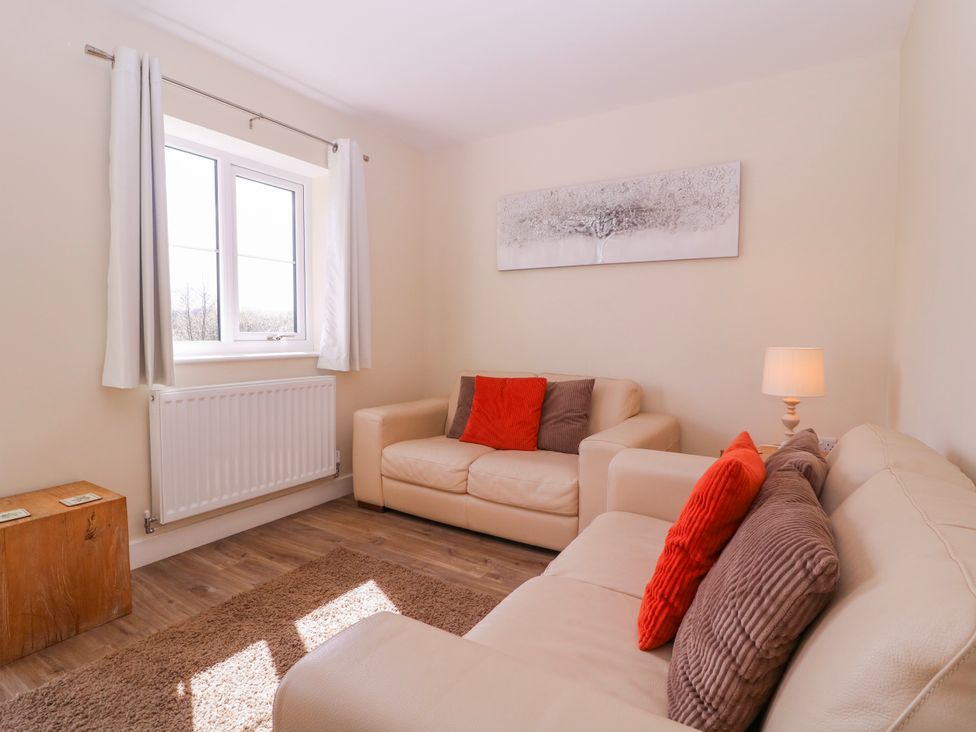 A living room with a sofa and a lamp at Country Cottage in Brecon
