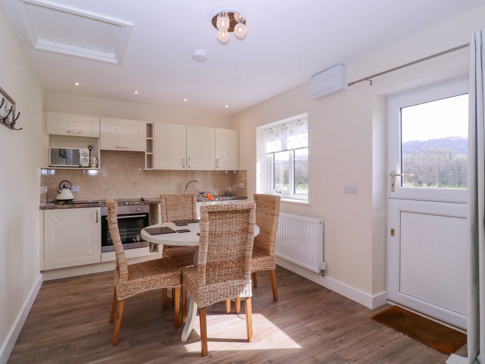 A kitchen with dining table and chairs at Country Cottage Brecon