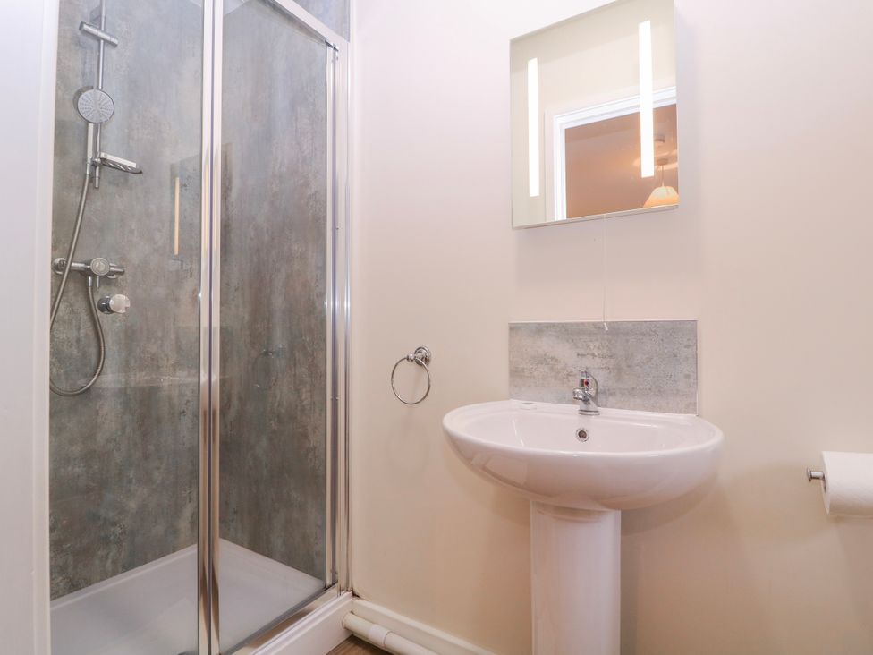 A bathroom with a shower and sink at Country Cottage in Brecon