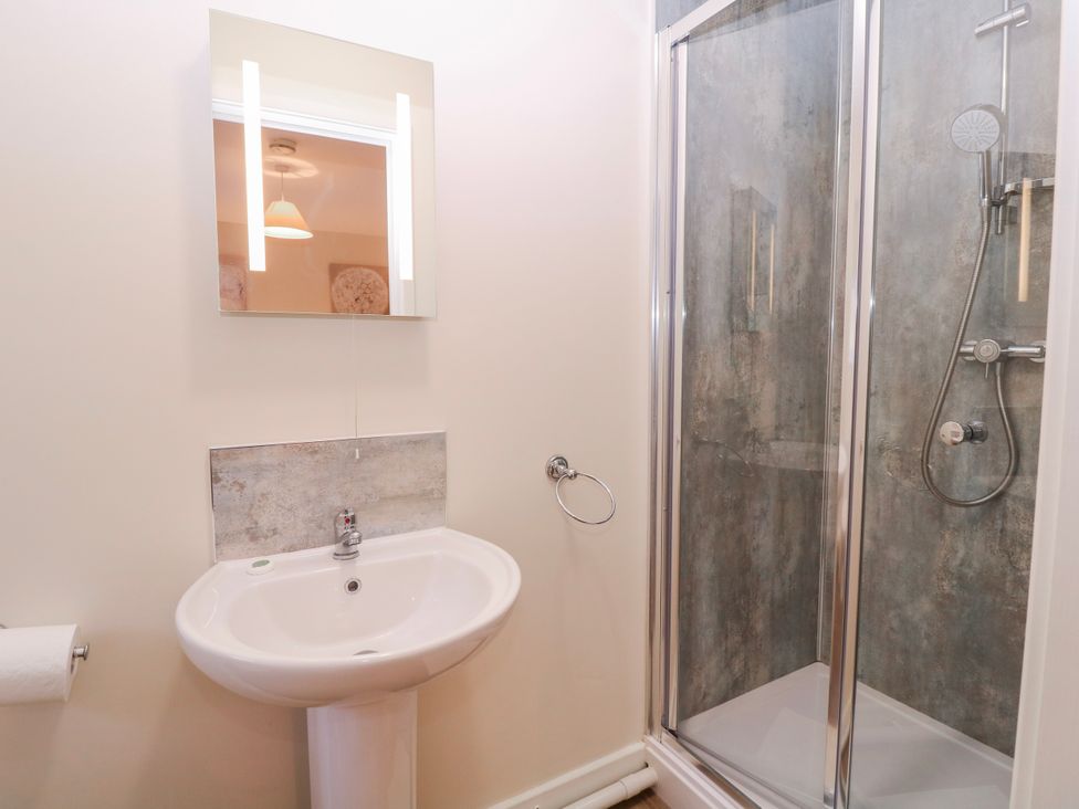 A bathroom with a sink and shower at Country Cottage in Brecon