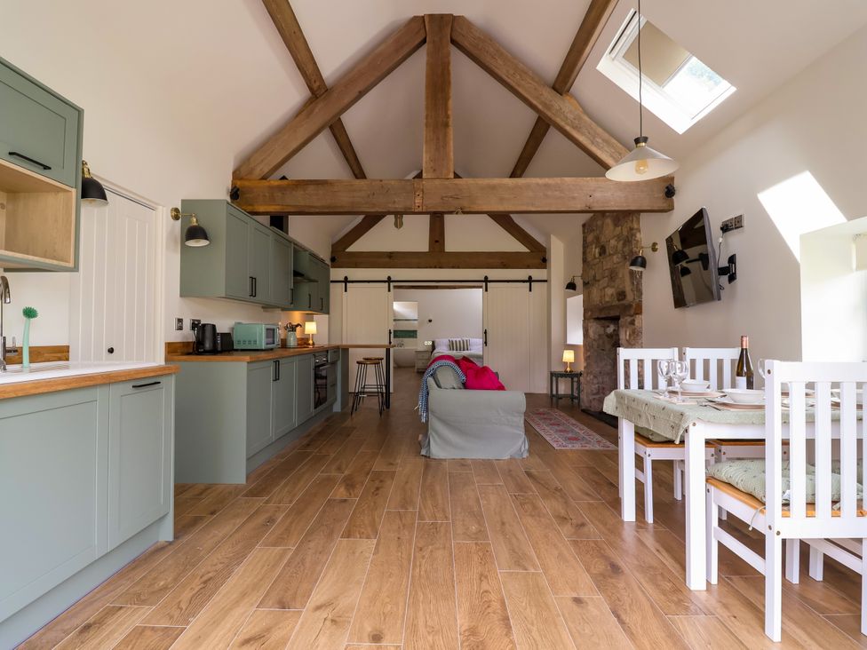 A living room with kitchen and dining area at The Barn Tafarn-Y-Gelyn