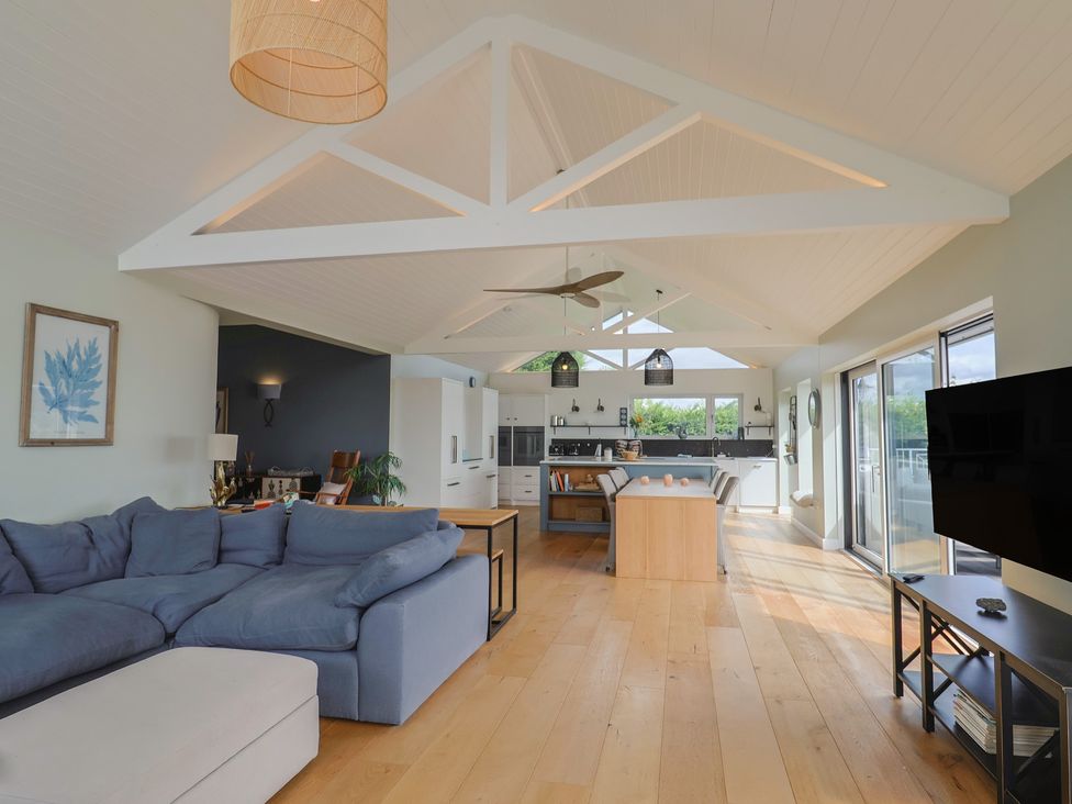 A living room with a sofa and table at 13 Downside Close in Charmouth