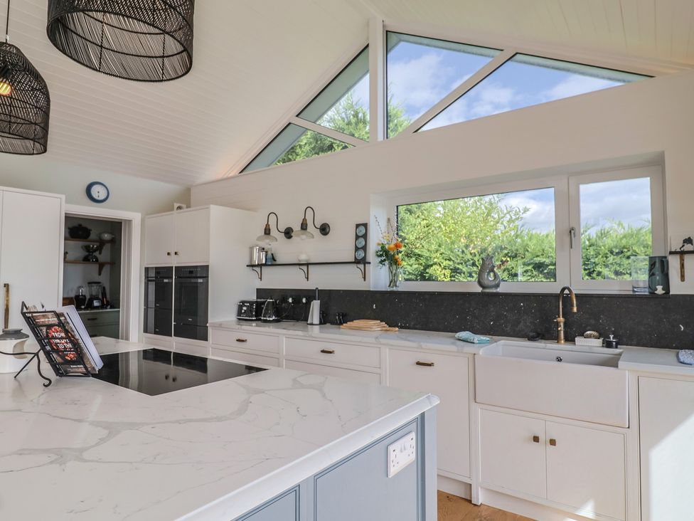 A kitchen with an island and modern appliances at 13 Downside Close in Charmouth