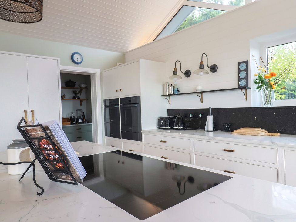 A kitchen with a cooktop and coffee maker at 13 Downside Close Charmouth