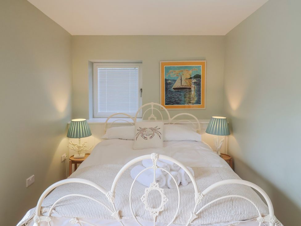 A bedroom with a bed and lamps at 13 Downside Close in Charmouth