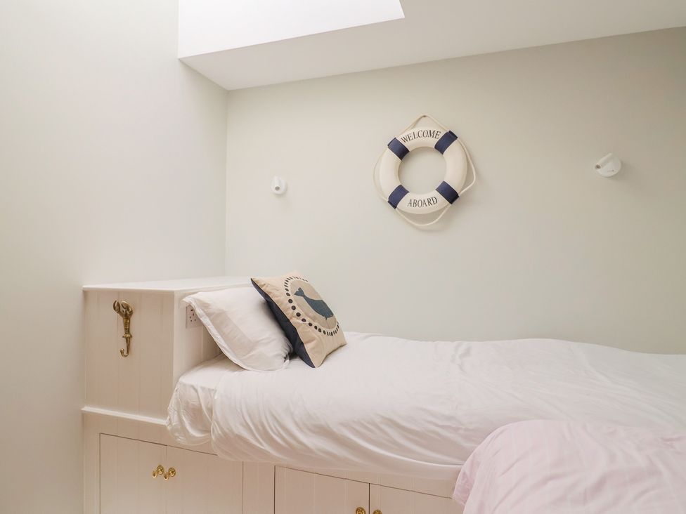 A bedroom with a bed and life preserver decoration at 13 Downside Close, Charmouth
