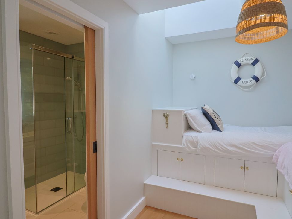 A bedroom with a shower and bed at 13 Downside Close, Charmouth