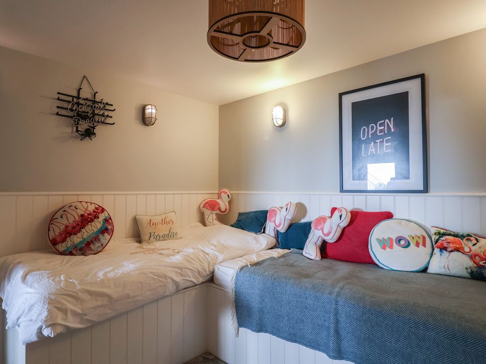 A bedroom with a bed and decorative pillows at 13 Downside Close in Charmouth