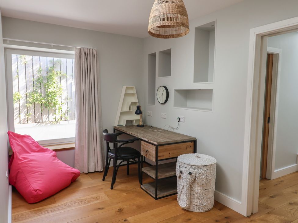 A home office with a desk and chair at 13 Downside Close, Charmouth